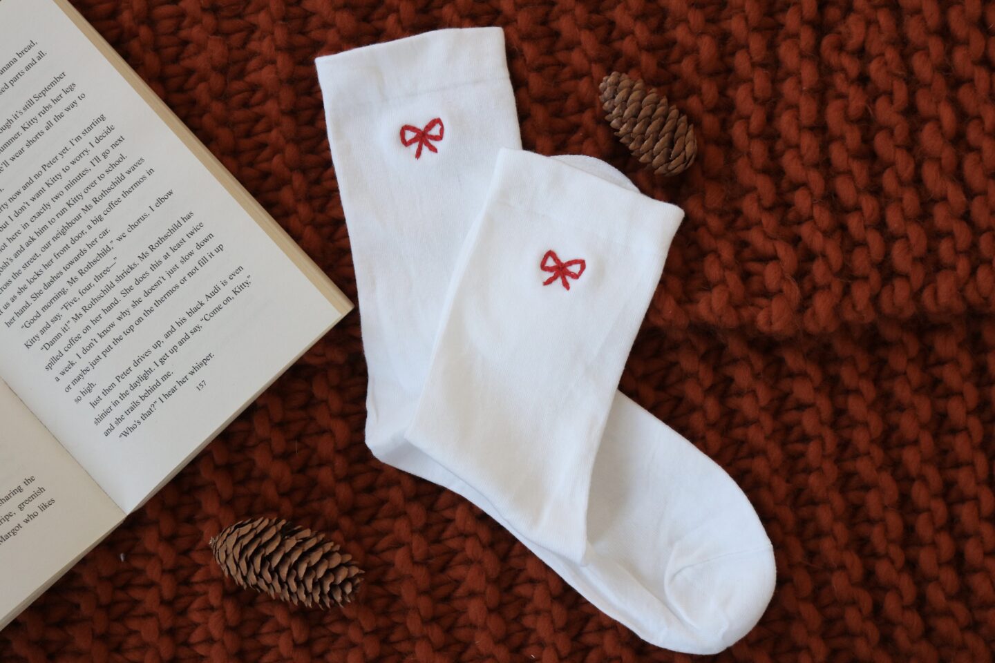 White cotton socks hand embroidered with a red bow