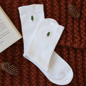 white cotton socks hand embroidered with an evergreen tree