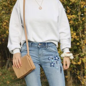 Blue denim jeans hand embroidered with blue flowers