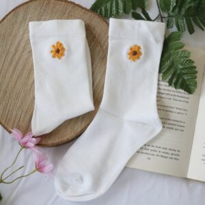 White cotton socks hand embroidered with a sunflower