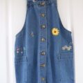 Blue denim pinafore hand embroidered with a sunflower and mini flowers